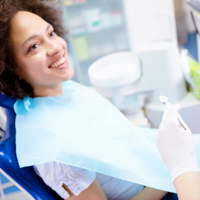 Woman at dental visit smiling 